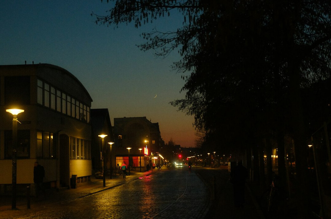 Danish city street reflecting streetlights on a rainy evening