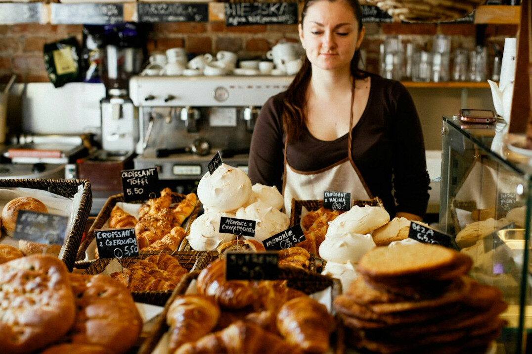 Portrait of a young Danish baker dusted with flour in a bakery