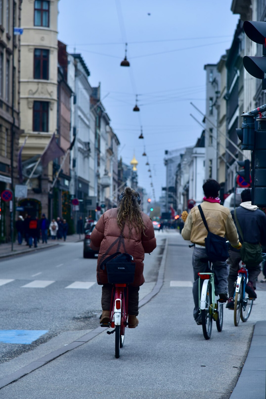 Commuters cycling through a Danish city street in the morning