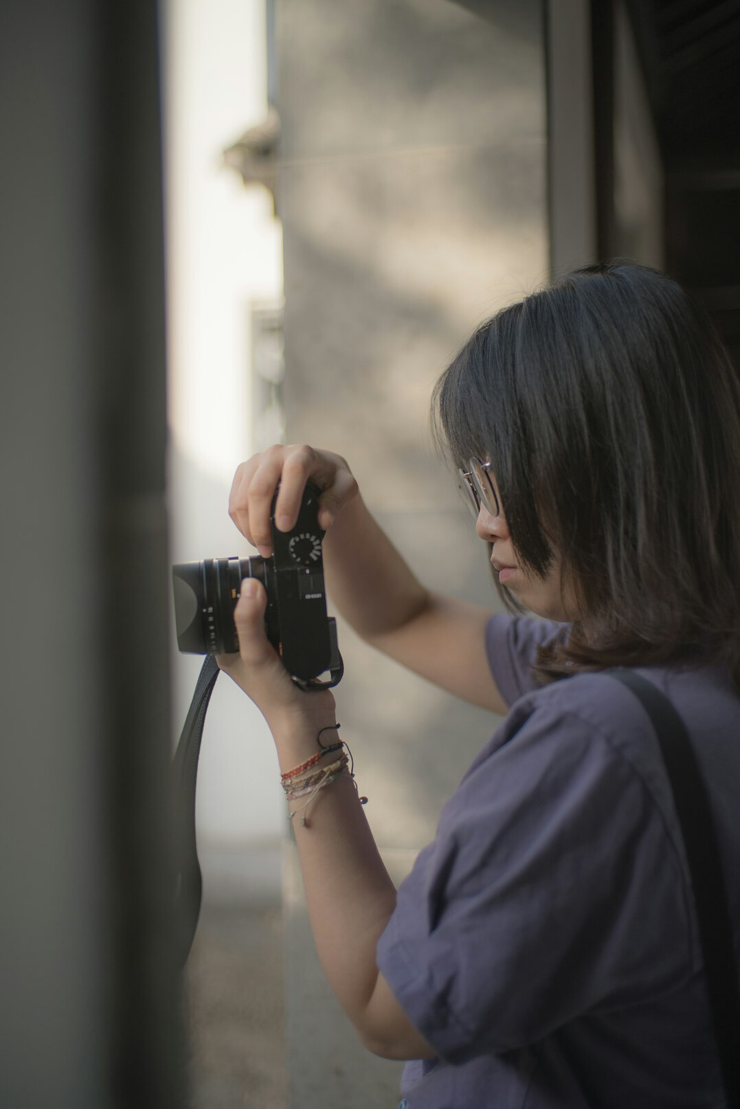 Danish woman documentary photographer holding a camera in soft natural light