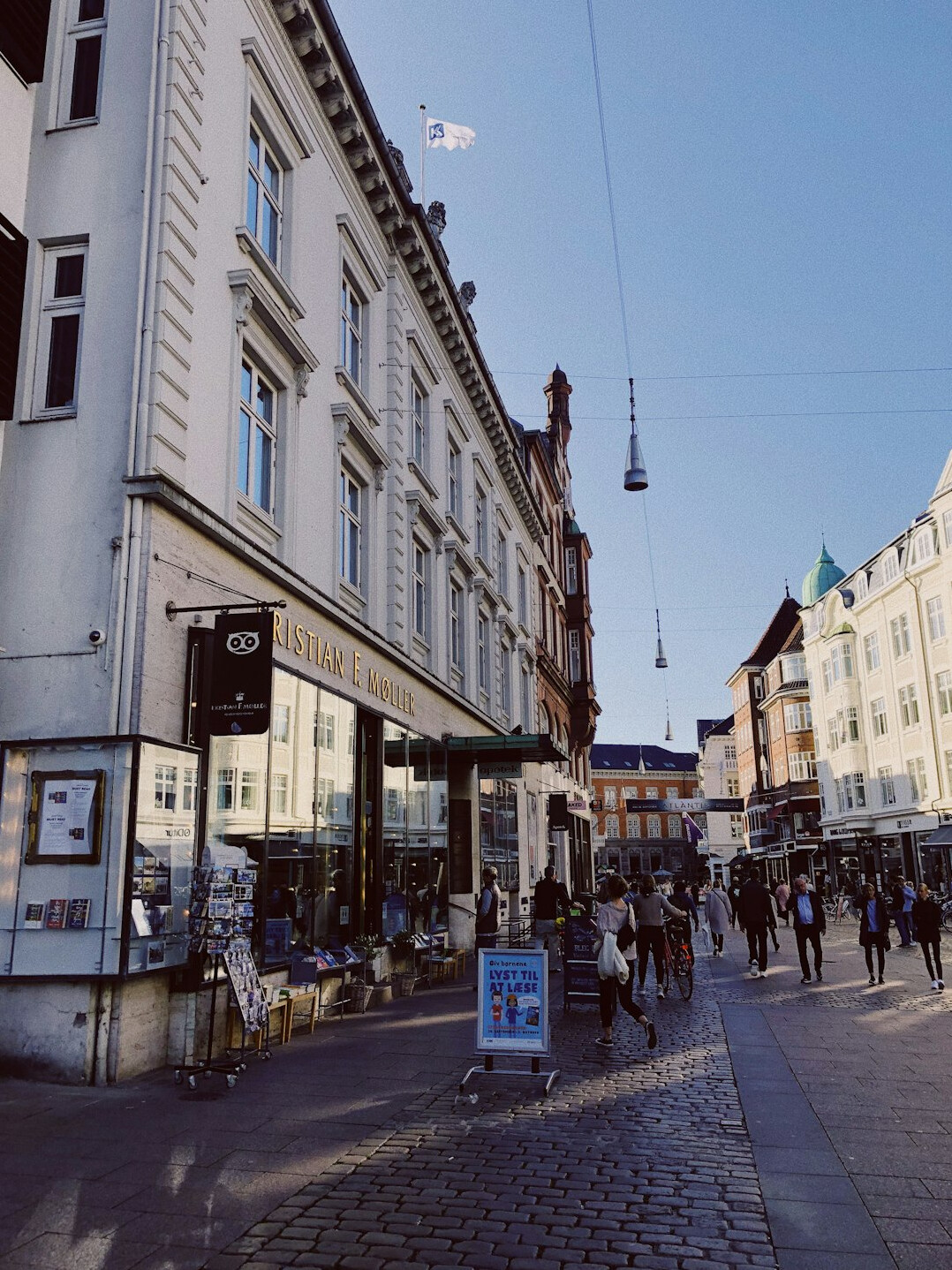 Busy outdoor market day scene in Aarhus with vendors and shoppers