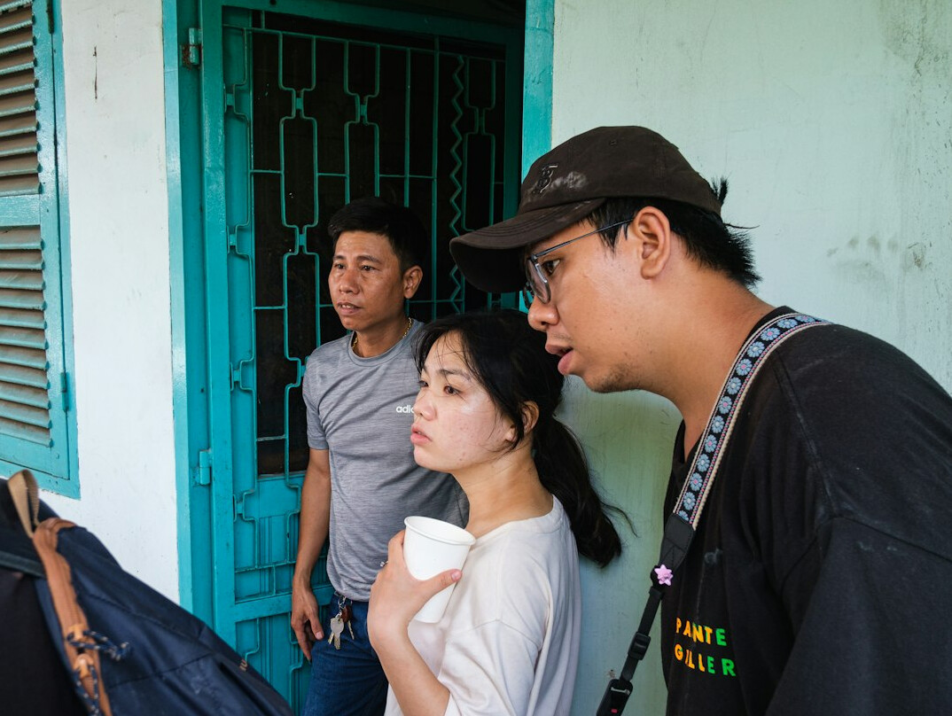 documentary photographer interviewing locals